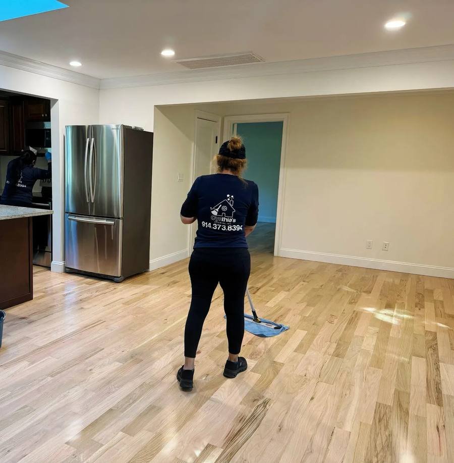 Mopping newly finished hardwood floors after a renovation